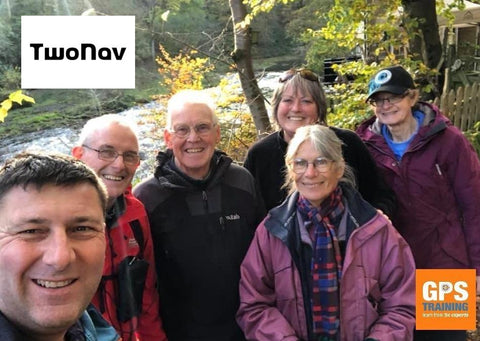 Group of people posing outdoors with 'TwoNav' and 'GPS Training' logos in the corners.